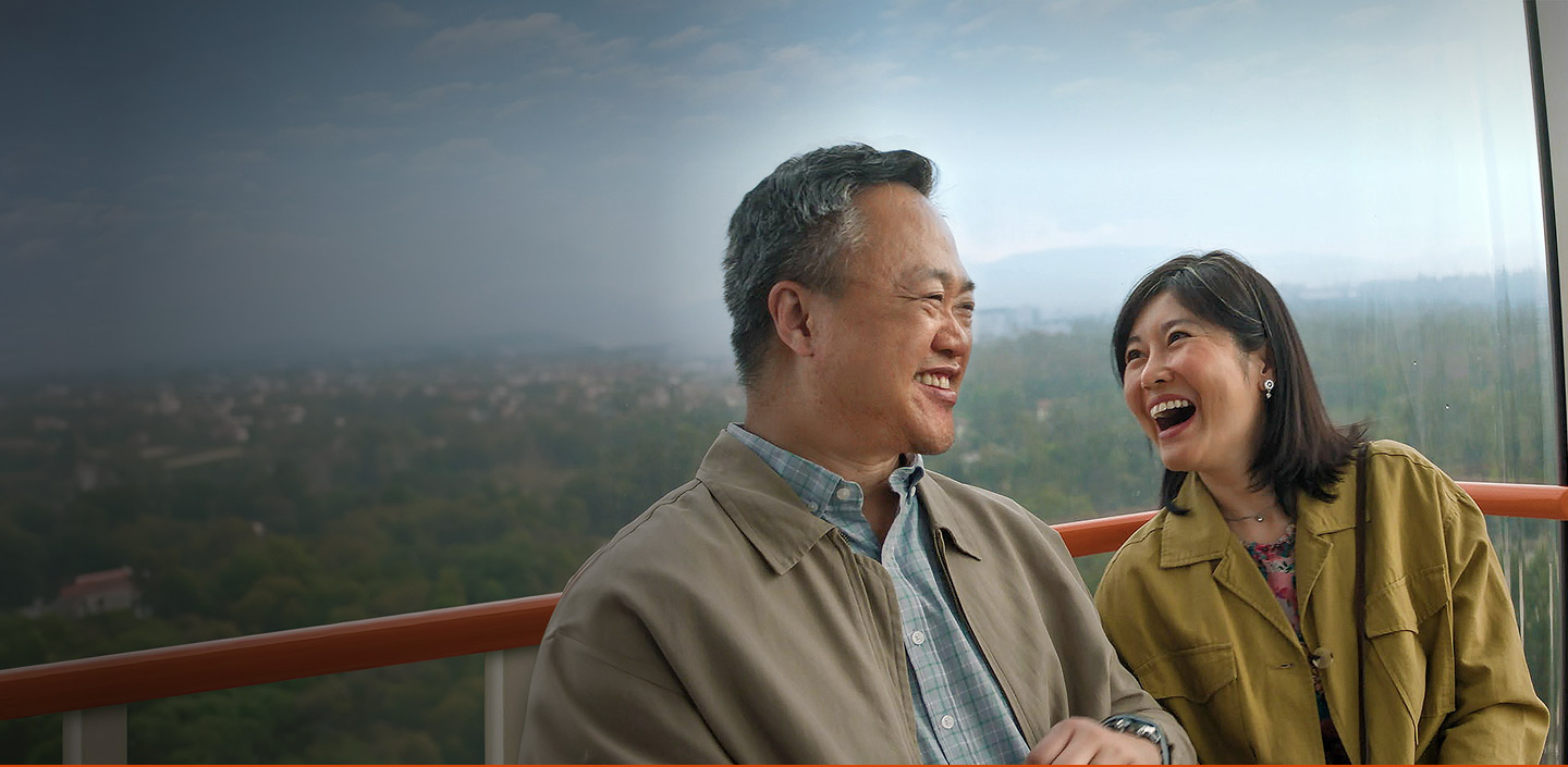 Man and woman laughing with each other outside