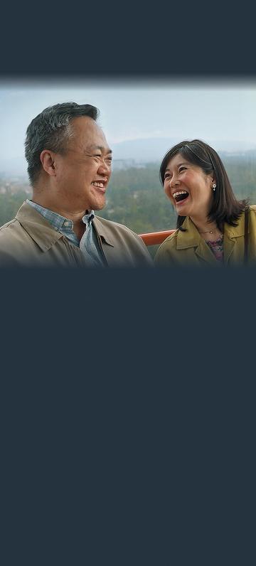 Man and woman laughing with each other outside