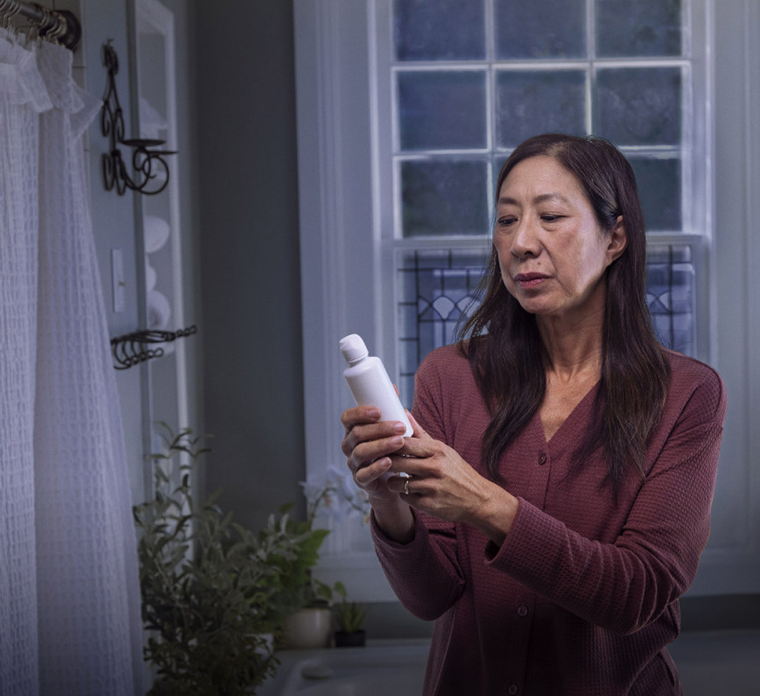 Woman reading a bottle label