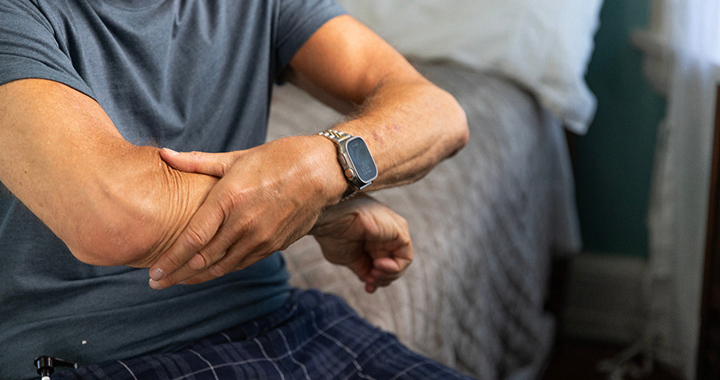 Man rubbing his arm